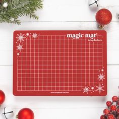 a red cutting board sitting next to christmas decorations