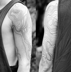 black and white photograph of two men's arms with tattoos on their arm, one showing