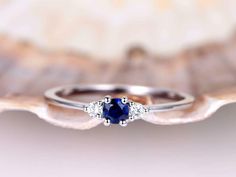 a blue sapphire and diamond ring on a shell