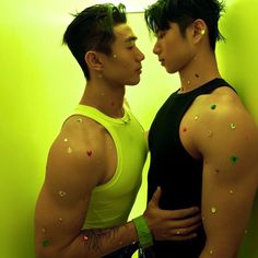 two young men standing next to each other with sprinkles on their body