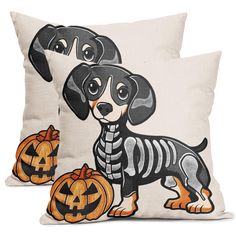 two pillows with dogs in skeleton costumes on them