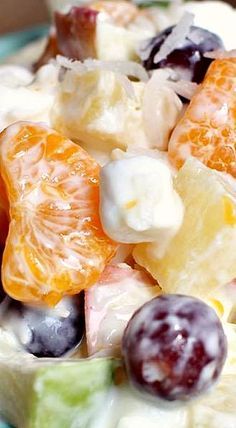 a blue bowl filled with fruit salad on top of a table