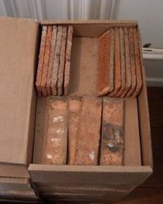 an open cardboard box filled with different types of bricks