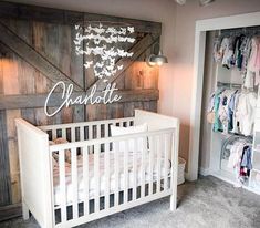 a baby's room with a crib and wooden walls