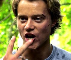 a young man making a weird face with his finger