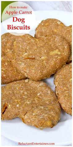 four apple carrot dog biscuits on a white plate