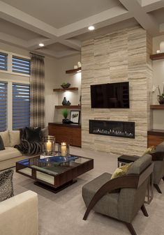 a living room filled with furniture and a flat screen tv mounted on the wall above a fireplace