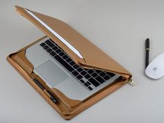 an open laptop computer sitting on top of a desk next to a mouse and keyboard