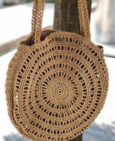 a crocheted bag hanging from a tree