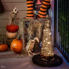 halloween decorations with pumpkins and skeletons on the porch