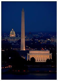 the washington monument is lit up at night in front of the capitol building and lincoln memorial