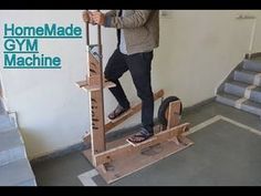 a man standing on top of a machine in front of stairs with the words homemade gym machine