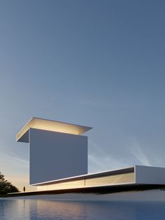 a white building sitting on top of a body of water