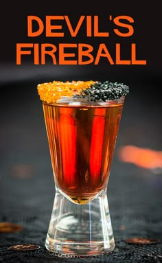 the devil's fireball cocktail is garnished with blackberries and orange peels