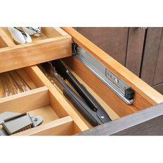 an open drawer with knives and spoons in it