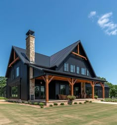 a large black and brown house with lots of windows