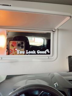 the inside of a vehicle with a sticker on it that says you look good