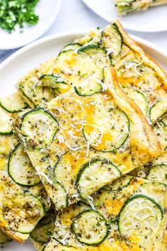 zucchini and cheese frittata on a white plate with parmesan cheese