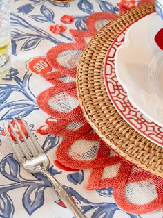 a close up of a plate on a table with utensils and water glasses