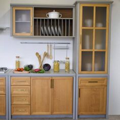 a kitchen with wooden cabinets and gray counter tops