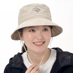 a woman wearing a hat and smiling at the camera