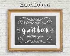 a chalkboard with the words please sign our guest book thank you