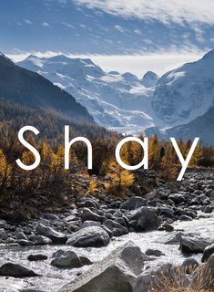 the words shanay are over a river with mountains in the background