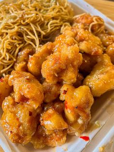 a white plate topped with meat and noodles