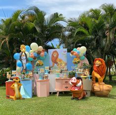 the lion king birthday party is set up in front of some palm trees and balloons