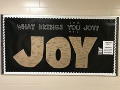 a bulletin board with writing on it that says what brings you joy? and the word joy written in cursive letters