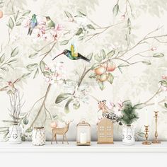 the wallpaper is decorated with birds, flowers and deers on it's mantle