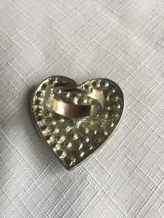 "Pave clear rhinestone heart shaped ring, very 70s. The heart is about 1.625 wide and tall. Classic cocktail ring, retro elegant. Size 8.5, but it's adjustable so it would fit to about size 10.5 comfortably. Could also be used as a scarf ring. Please know that if you don't like the way the ring fits, you can return it; you pay for the shipping, but there's no restocking fee or questions asked, I just refund the ring's cost. Also, please take a look at my storefront at: https://www.etsy.com/shop/ Vintage Metal Crystal Promise Ring, Silver Heart-shaped Metal Ring, Vintage Open Heart Ring For Promise, Vintage Open Heart Promise Ring, Silver Heart Shaped Metal Ring, Metal Heart Ring For Valentine's Day, Metal Rings For Anniversary On Valentine's Day, Vintage Heart Cut Ring As A Gift, Metal Heart Ring As Gift