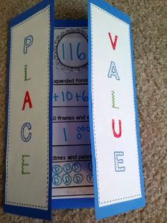 two bookmarks with numbers and letters on them sitting on the floor next to each other