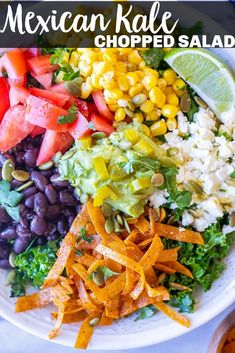 a white bowl filled with lots of different types of food on top of a table