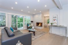 a living room filled with furniture and a fire place in the middle of a room