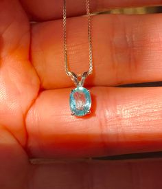 "Beautiful, dainty/minimalist, but will definitely not gone unnoticed, natural, paraiba, and paraiba color: known for its bright neon colours. The colour ranges from blue to green. Stone size: 7*5mm, 0.90 carats, set in 925 sterling silver, with 18\" inches long sterling silver box chain." Blue Apatite Pendant Jewelry, Aquamarine Birthstone Pendant Jewelry, Light Blue Aquamarine Birthstone Jewelry, Turquoise Topaz Birthstone Jewelry, Minimalist Aquamarine Jewelry For Gift, Minimalist Aquamarine Jewelry Gift, Minimalist Blue Jewelry With Prong Setting, Dainty Blue Aquamarine Jewelry, Dainty Blue Topaz Jewelry