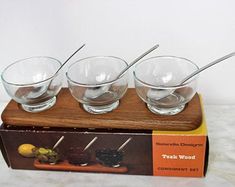 four glasses sitting on top of a wooden box