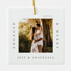 an ornament with the words engagged on it and a photo of two people