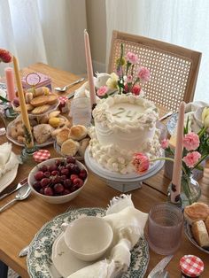 a table topped with lots of different types of cakes and desserts on top of plates