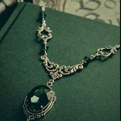 a green book with a necklace on it