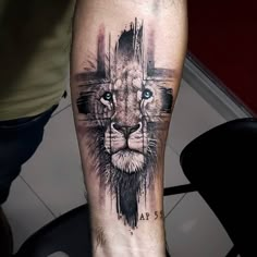 a man's leg with a lion and cross tattoo on it