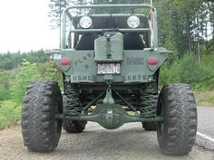 an army truck is parked on the side of the road