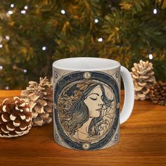 a coffee mug with a woman's face on it and pine cones in the background