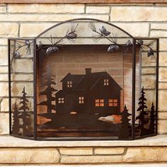 a fireplace screen with a house and trees on it