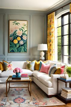 a living room filled with furniture and a large painting on the wall above it's windows