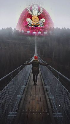 a person walking across a suspension bridge