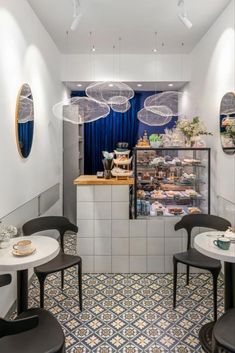 the interior of a restaurant with tables and chairs