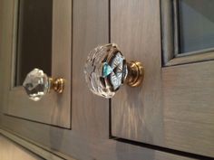 a close up of a cabinet door with glass knobs