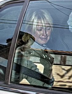 a woman sitting in the passenger seat of a car