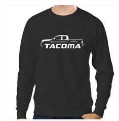 a man wearing a black tacoma sweatshirt with the word tacoma on it